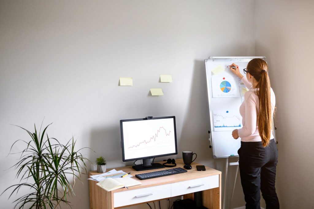 Young woman writes on a flip chart