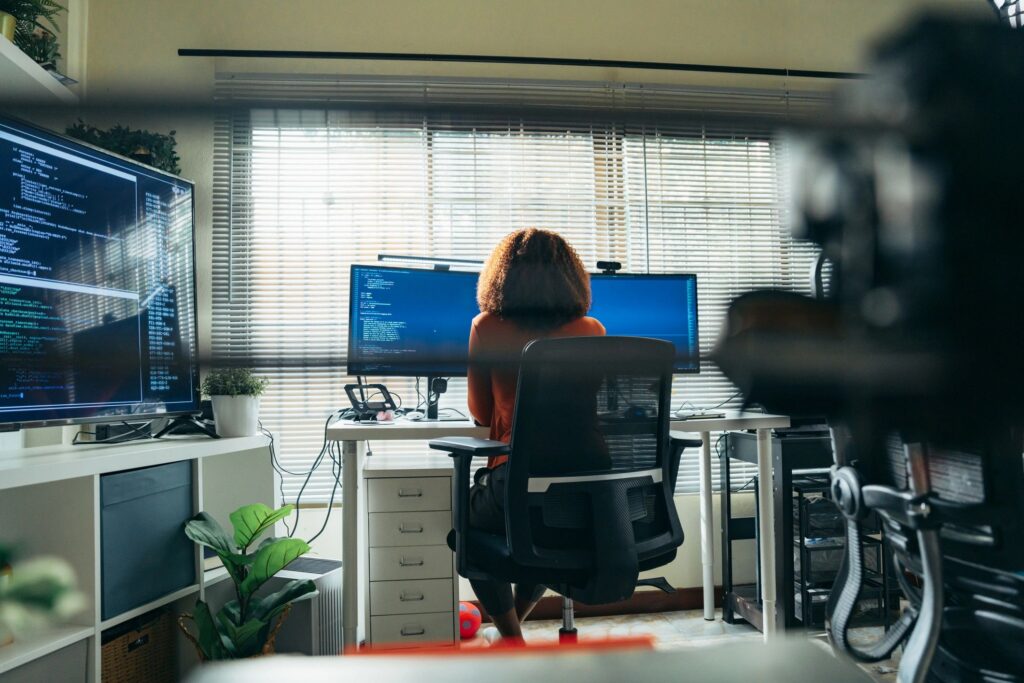 Female software developer thinking while working with code at a computer,